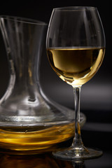 A glass full of wine and wine decanters