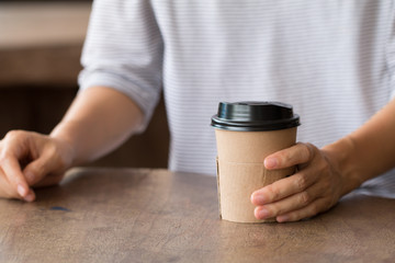 Woman enjoying warming drink, Late coffee in paper cup