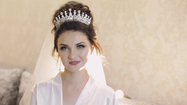 Beautiful and lovely bride in night gown. Wedding morning. Bride in crown. Slow motion