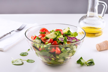 Fresh vegetable salad in a bowl on white background