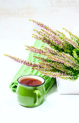 Bouquet of heather, tea mug and knitted scarf