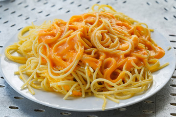 delicious macaroni with cheese and sauce on a plate