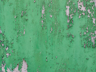 Background of rusty metal wall covered with paint peeling off