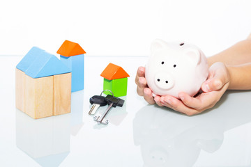 Mortgage, investment, real estate and property concept. On a light background. pink piggy bank