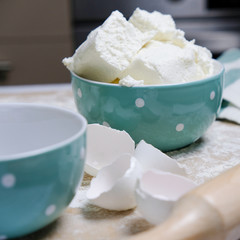 Cooking Process Of Homebaked Cottage Cheese Pie. Raw Ingredients In Cute Turquoise Bowl, Kitchen Objects, Preparation A Homemade Cake.