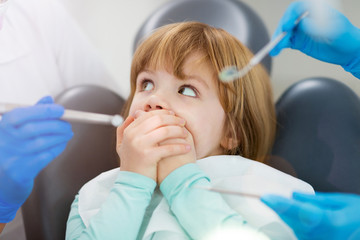 Child refuses to show her teeth at dental clinic