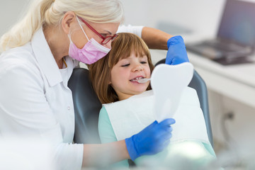 Female dentist and her child patient 