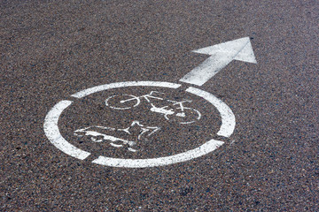 Bicycle, roller scates sign on asphalt paths on city park
