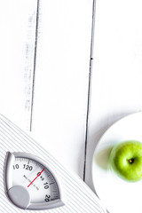 floor scale and apple on wooden background top view