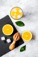 freshly squeezed orange juice on concrete background top view