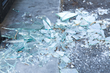 damage concept - shards of broken glass on floor