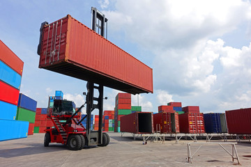 Top reach stacker is handling 40' high cube empty to put on repait bar yard in container depot service during day time.