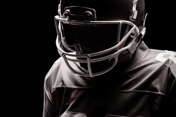 American football player standing with rugby helmat