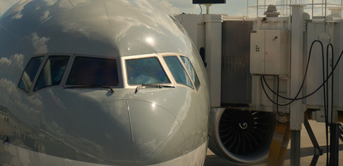 Fototapeta premium Airplane standing at the airport gate with the passenger boarding bridges connected