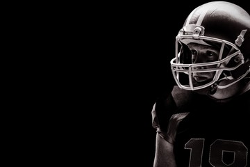 American football player standing with rugby helmet
