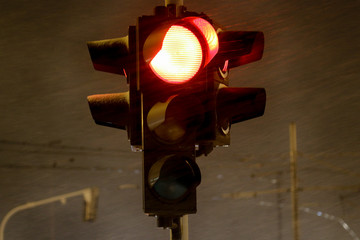 Traffic light at night, snow