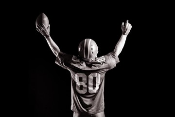 Fototapeta na wymiar American football player cheering with arms up
