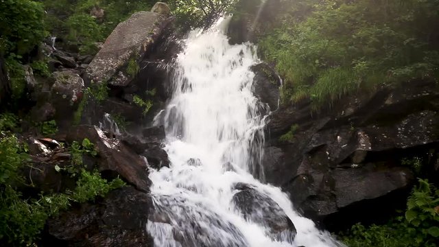 Mountain waterfall at summer green forest