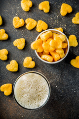 Beer and heart snack, treatment idea for Valentine's day, dark rusty background copy space