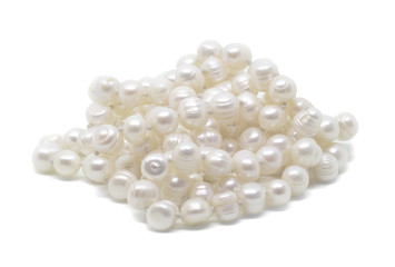Natural cultered white pearl beads string on a white background isolated