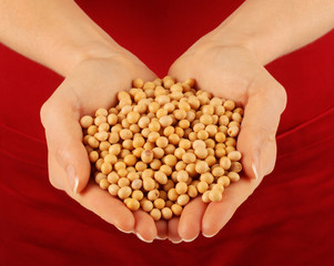 WOMAN WITH HANDFUL OF SOYA BENAS
