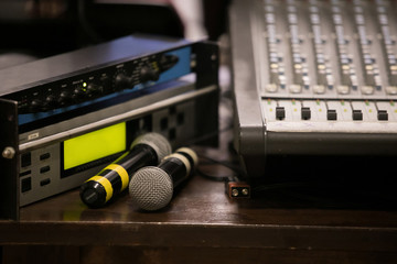 Audio engineer operating mixing console with hands