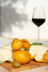 Smoked and white Fresh South Italian traditional cow or cow and sheep semi-soft cheese Scamorza served outdoor on olive wood board