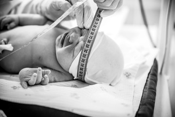 The head of a newborn baby is measured after birth.
- 234885491