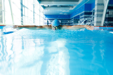 Photo of sportive man swimming in pool