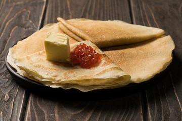 Traditional russian pancakes with butter and caviar