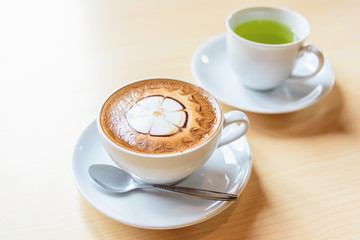 hot cappuccino coffee with nice pattern foam on table