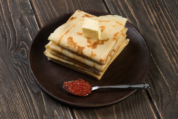 Pancakes with spoon with red caviar and butter