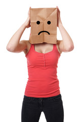 young woman wearing paper bag with sad smiley face over her head