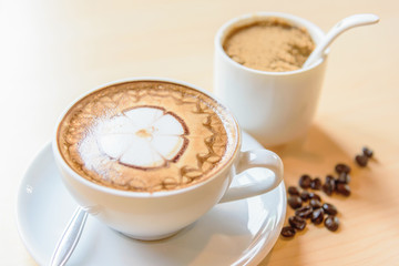 hot cappuccino coffee with nice pattern foam on table