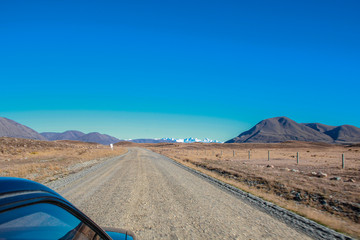 Obraz premium dirt road leading to mountains in Ashburton Lakes District, South Island, New Zealand