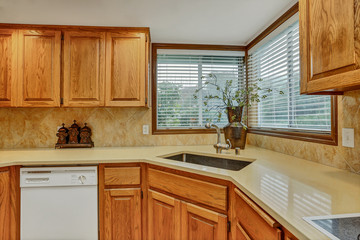 Open large kitchen interior with vaulted ceiling and white appliances.