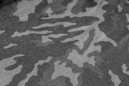 Old camouflage cloth with blur effect in black and white.