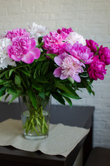 Fototapeta na wymiar bouquet of flowers peonies in a vase on wooden table