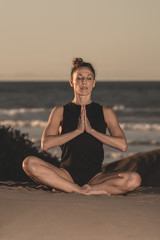 Fototapeta na wymiar Woman in solitude on beach meditating