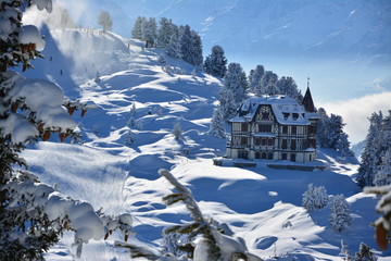 Winter landscape in the alps on bettmeralp with villa - obrazy, fototapety, plakaty