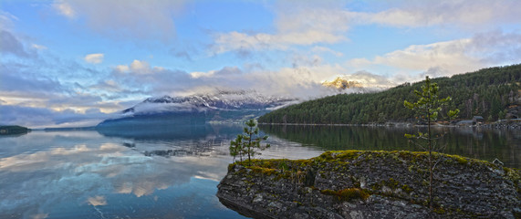 Landscape with glassy lake and mountains