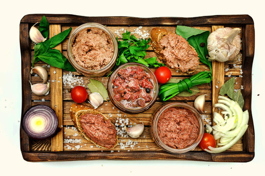 Meat pates on wooden background top view