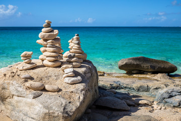 Fototapeta na wymiar Stacks of stones in balance at a beach