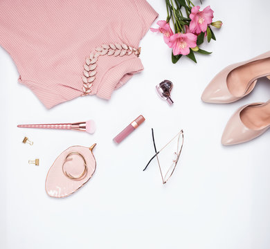 Stylish pale pink feminine accessories on the white background.