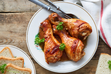 Chicken legs with tomato sauce and spices on a plate