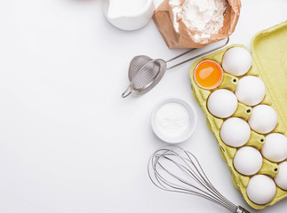 Tools and ingredients for baking: flour, eggs, milk and other.