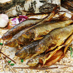 Smoked siberian fish on wooden background