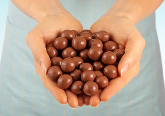 WOMAN HOLDING CHOCOLATE  MALTESERS