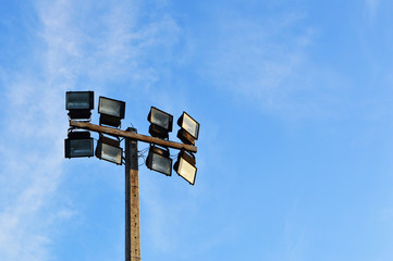 electric pole stadium light and blue sky - stadium spot light tower