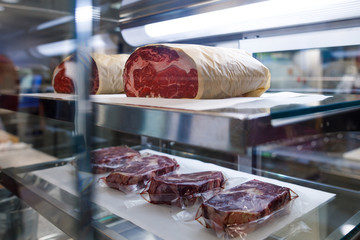 luxury ripe beaf steak on the glass shelves